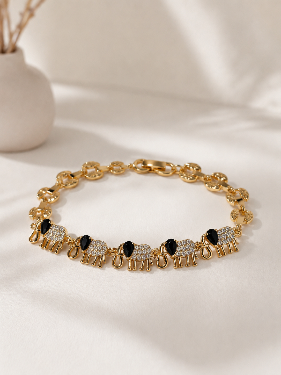 gold plated ladies bracelet with crystal elephants