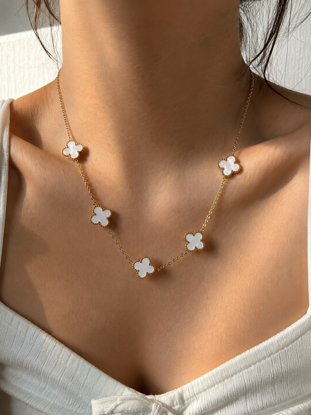 Stainless Steel Necklace Features Five White Clover.