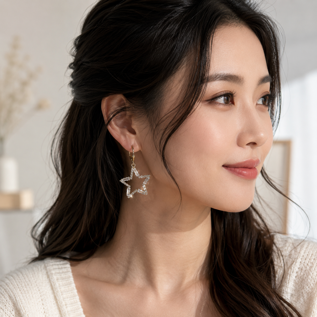 gold plated ladies earrings with star shape and white stones