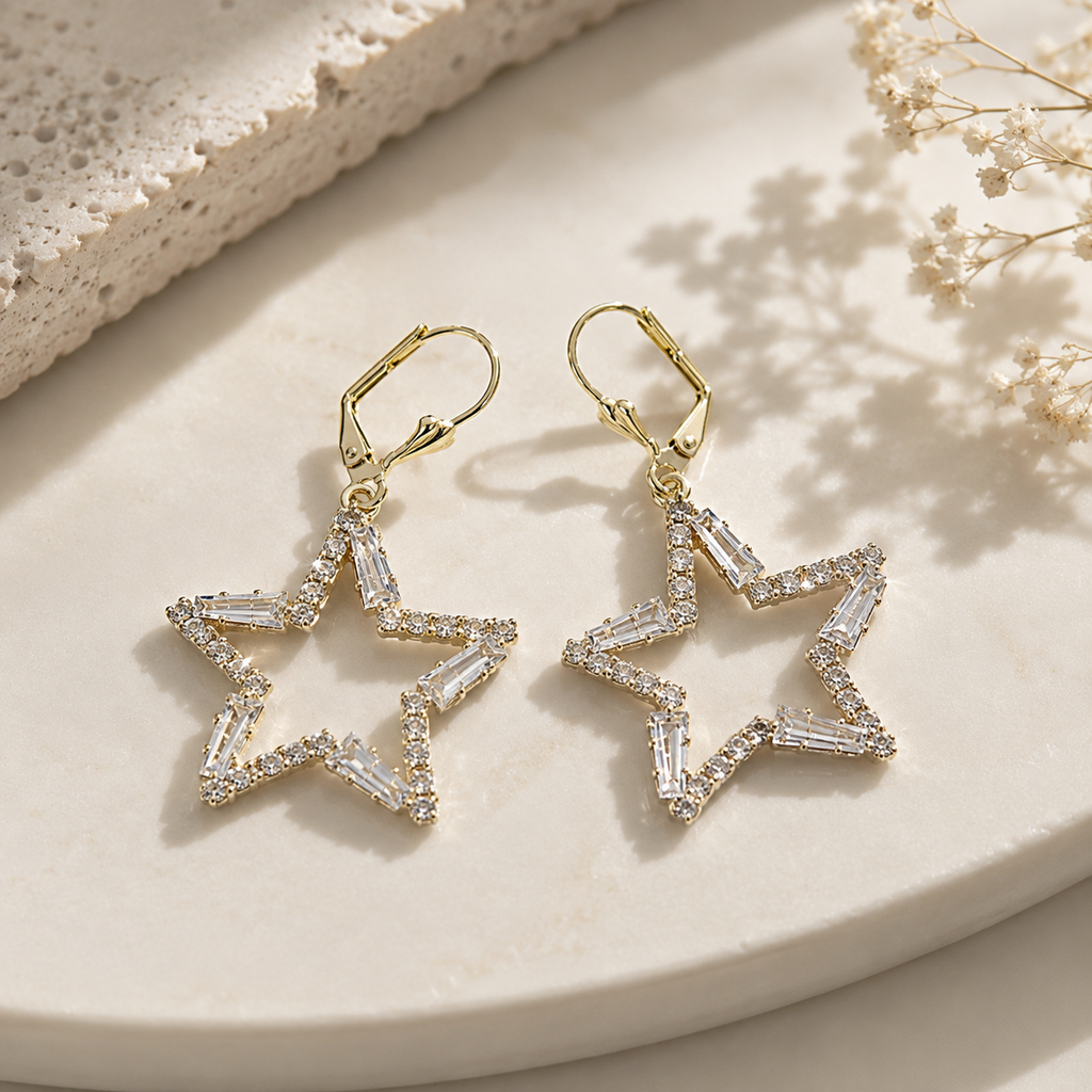 gold plated ladies earrings with star shape and white stones